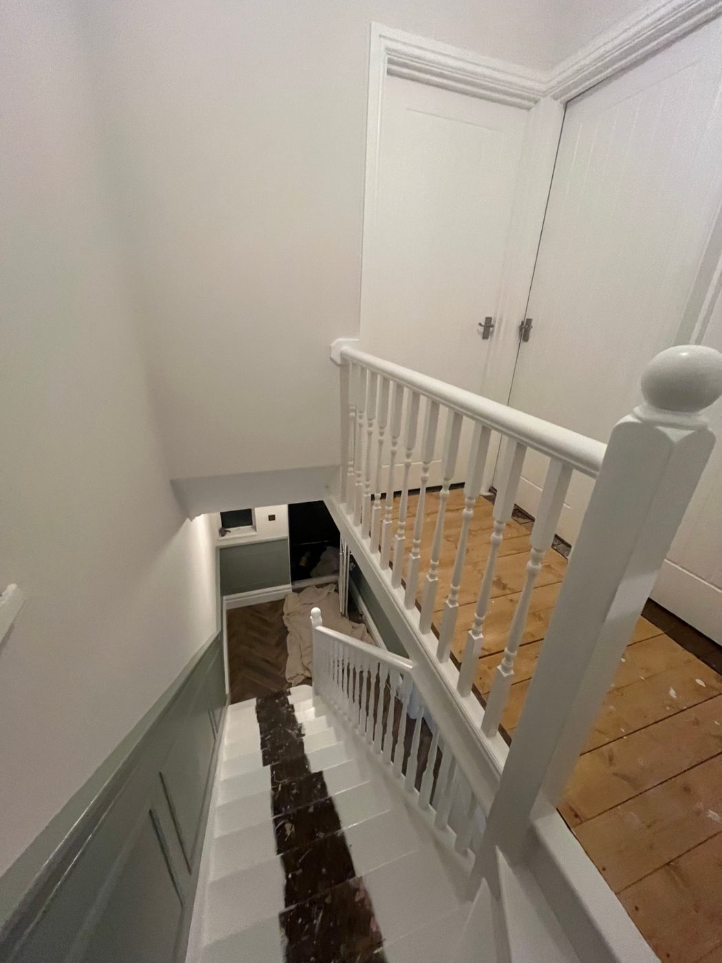 Landing & banister: Spindles, newel post and doors brought back to a bright, even white.